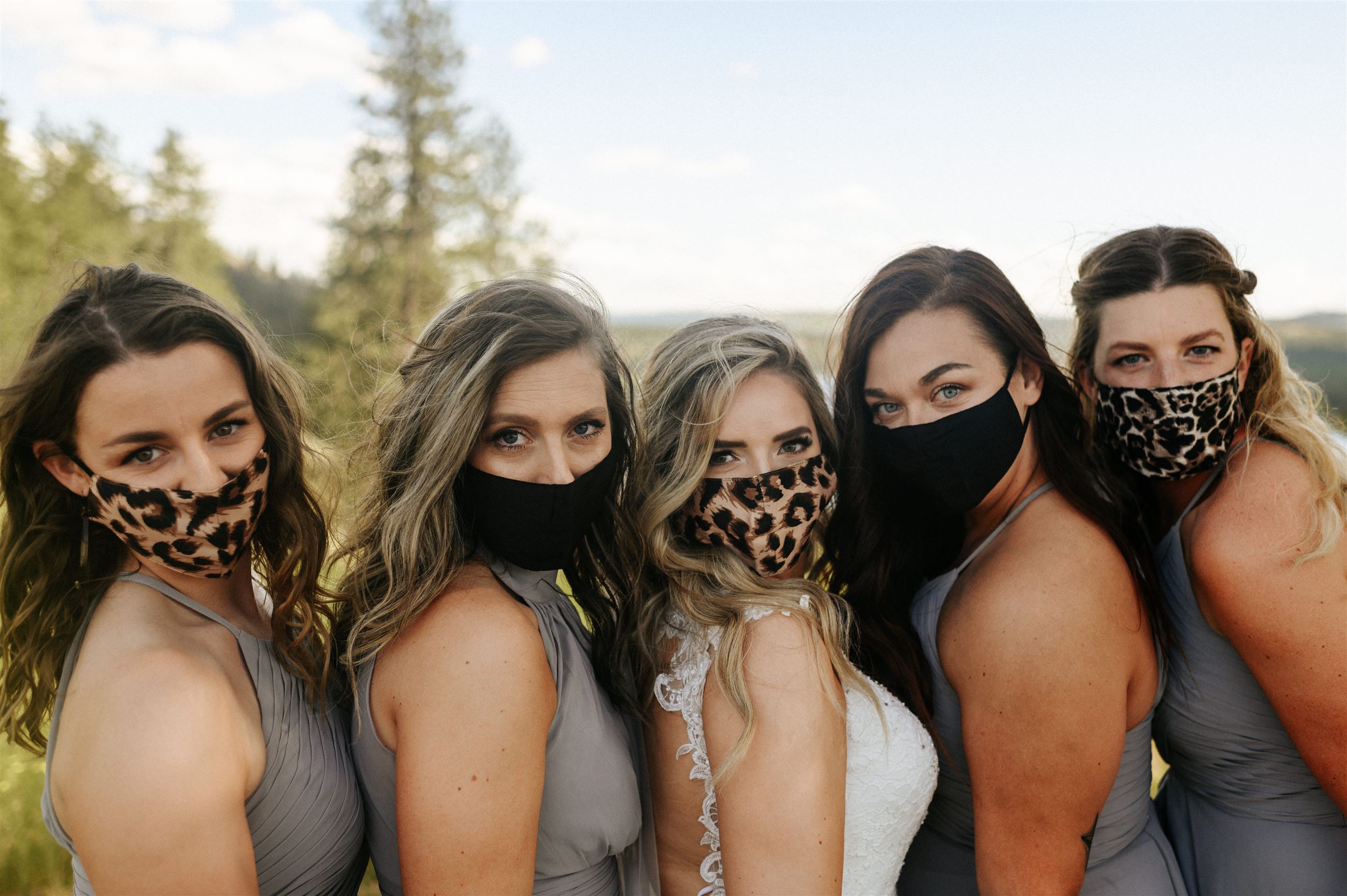 Bride and bridesmaids wearing masks